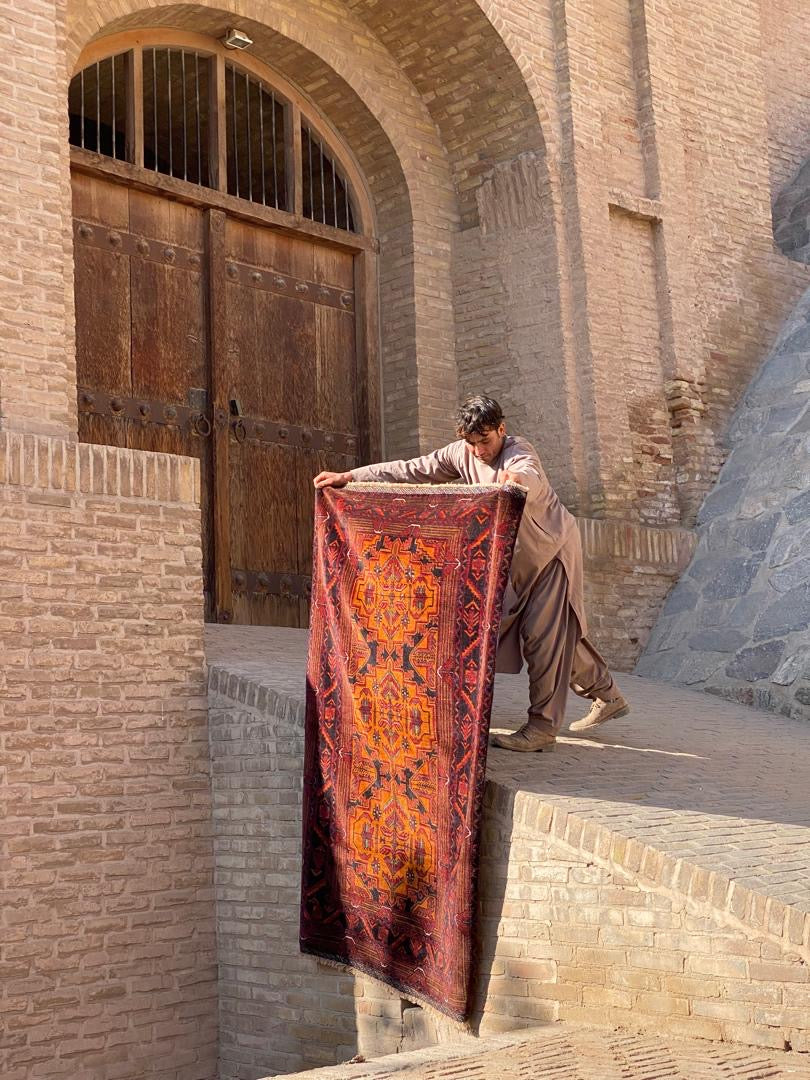 Handwoven Afghan rug with traditional geometric pattern from Herat, Afghanistan