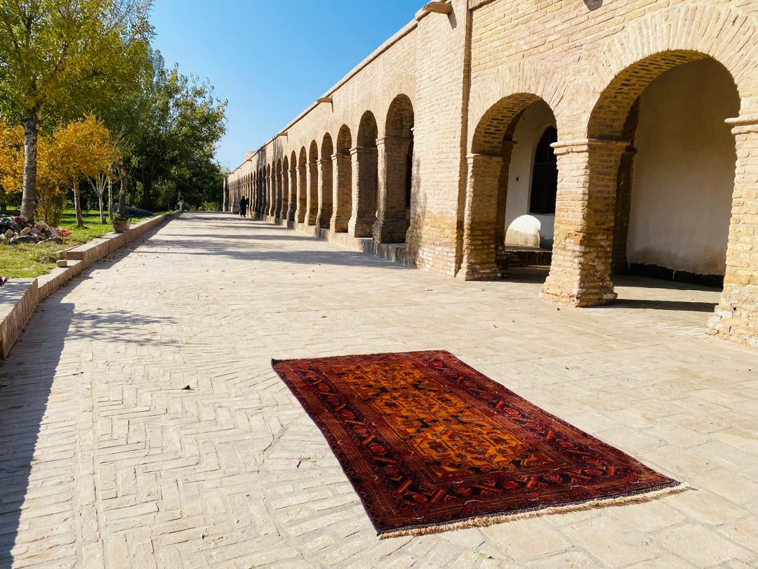 Handwoven Afghan rug with traditional geometric pattern from Herat, Afghanistan
